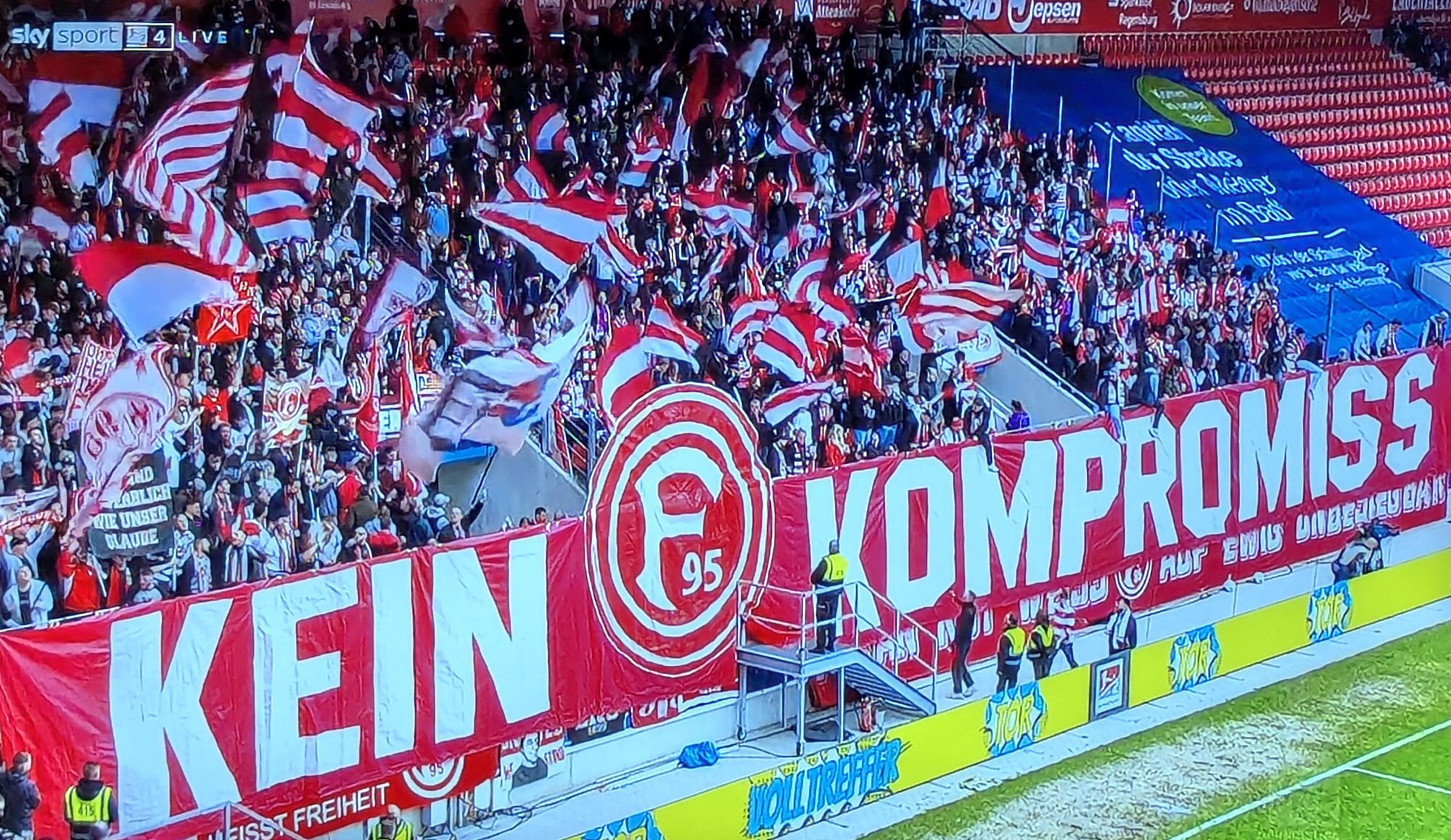 Regensburg vs F95: Die Ultras zeigen ihre Meinung zum falschfarbigen F95-Logo auf dem Ausweichtrikot (Screenshot Sky)